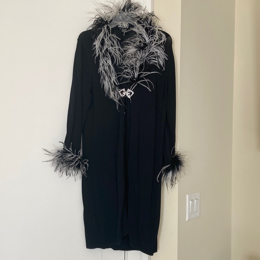 Elegant knit duster w/natural feather collar and cuffs. Rhinestone closure.